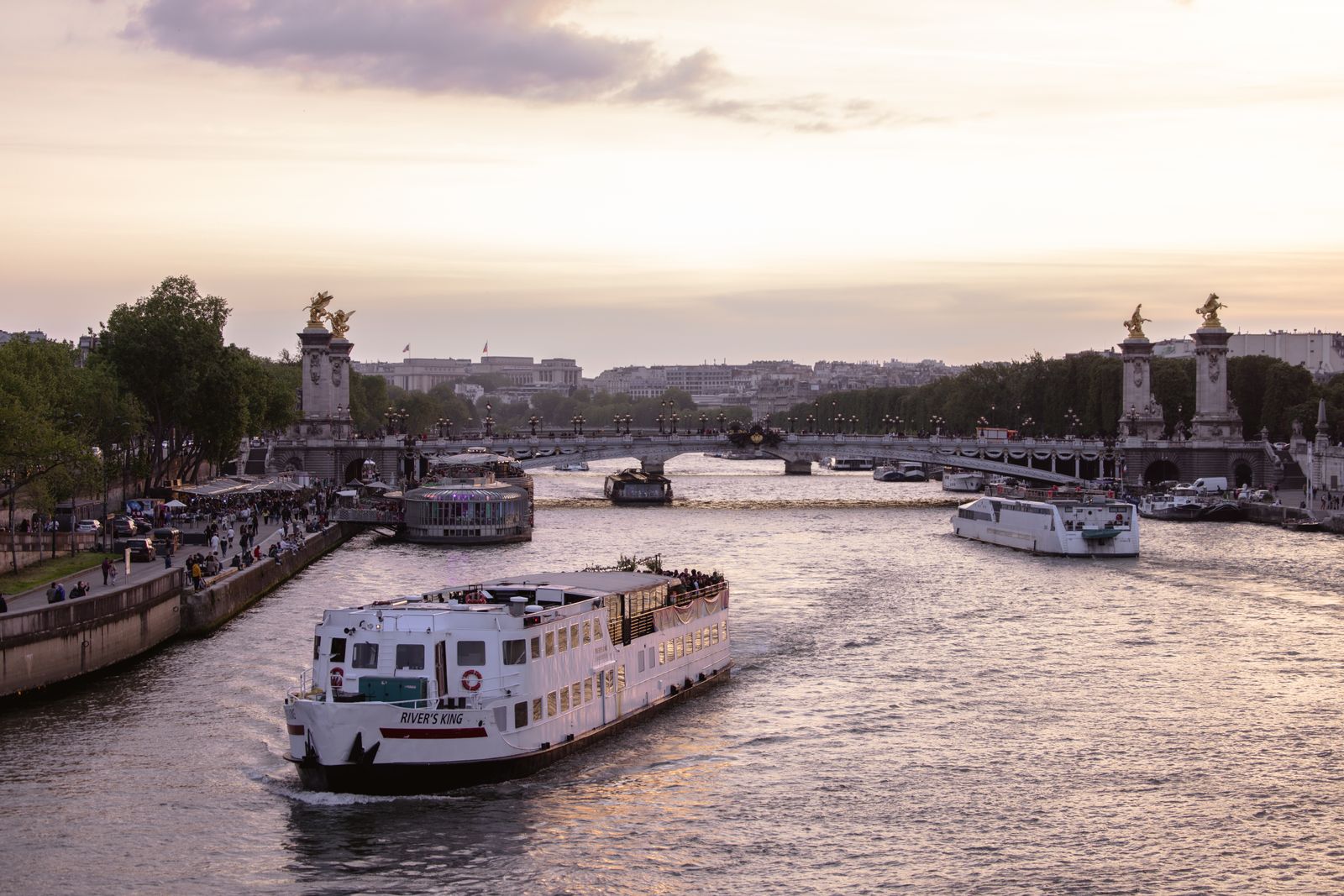Boats on the Seine near Pont Alexandre III at sunset